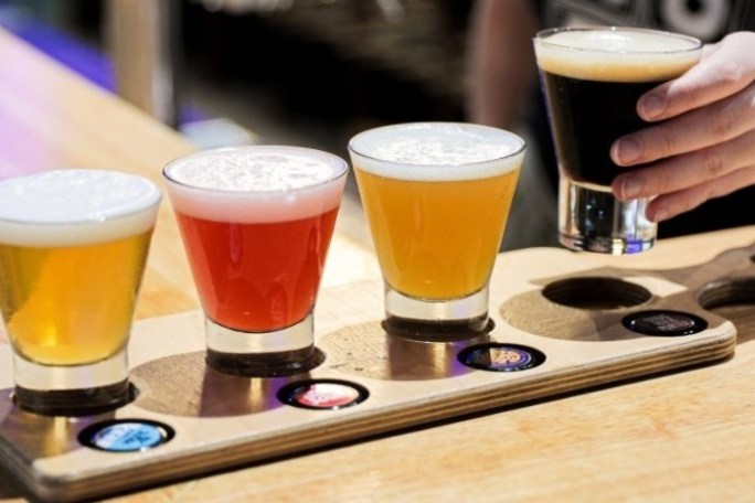 a cup of coffee and a glass of beer on a table